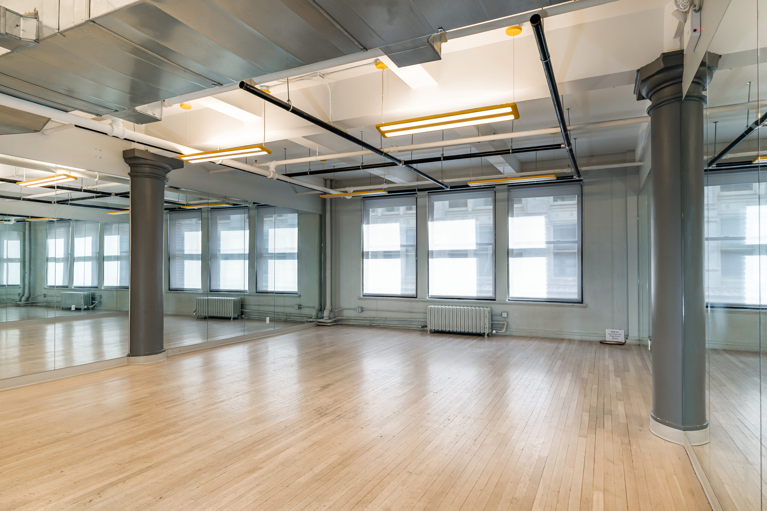 Dance studio at Three of Us Studios featuring full-length mirrors